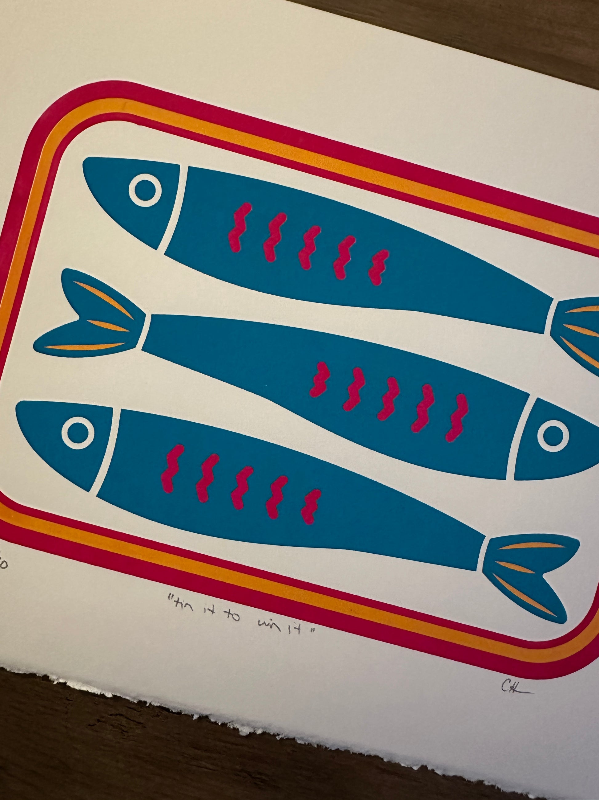 Illustration of three blue fish with red spots on a white background with a colorful border.