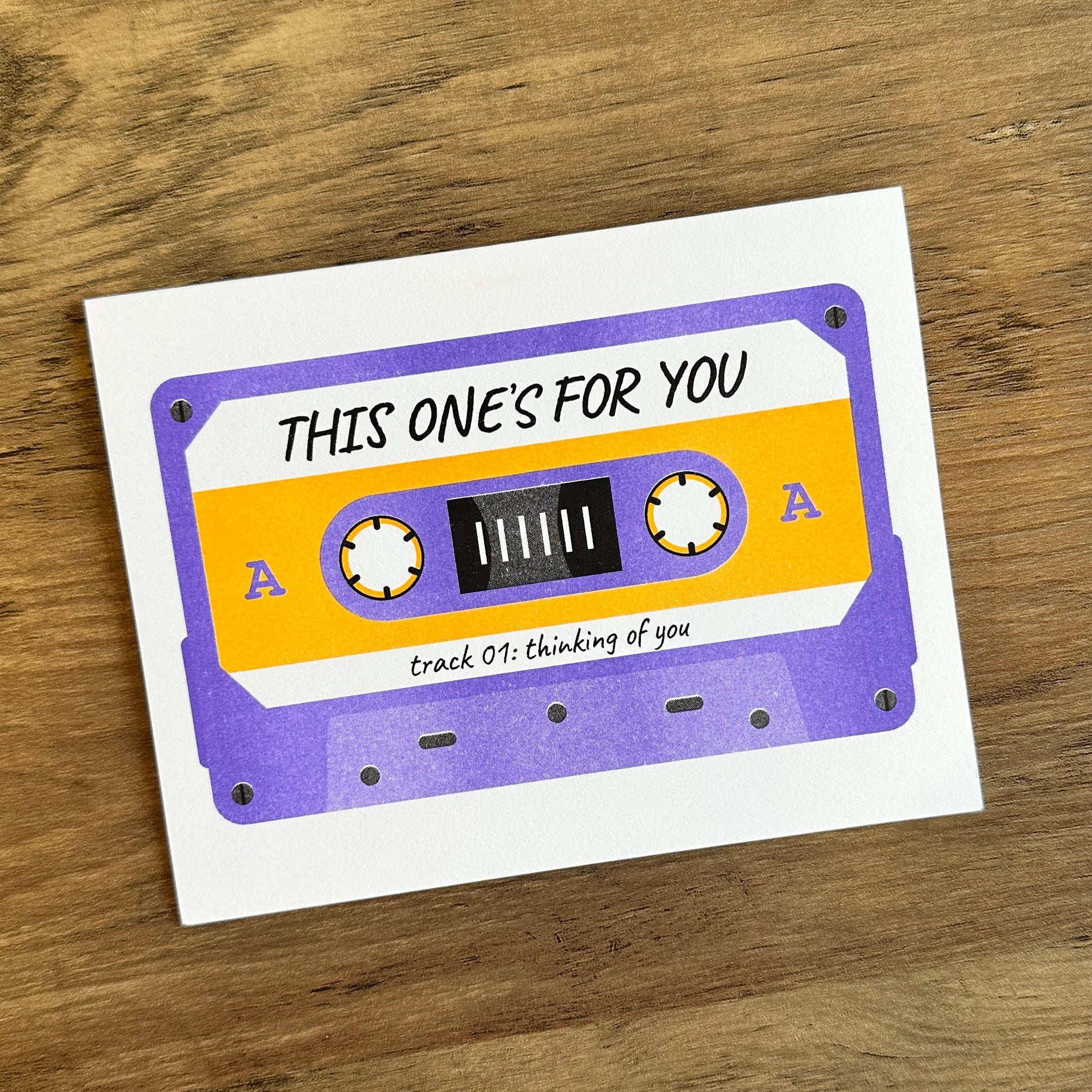 Card with a cassette tape design on a wooden surface