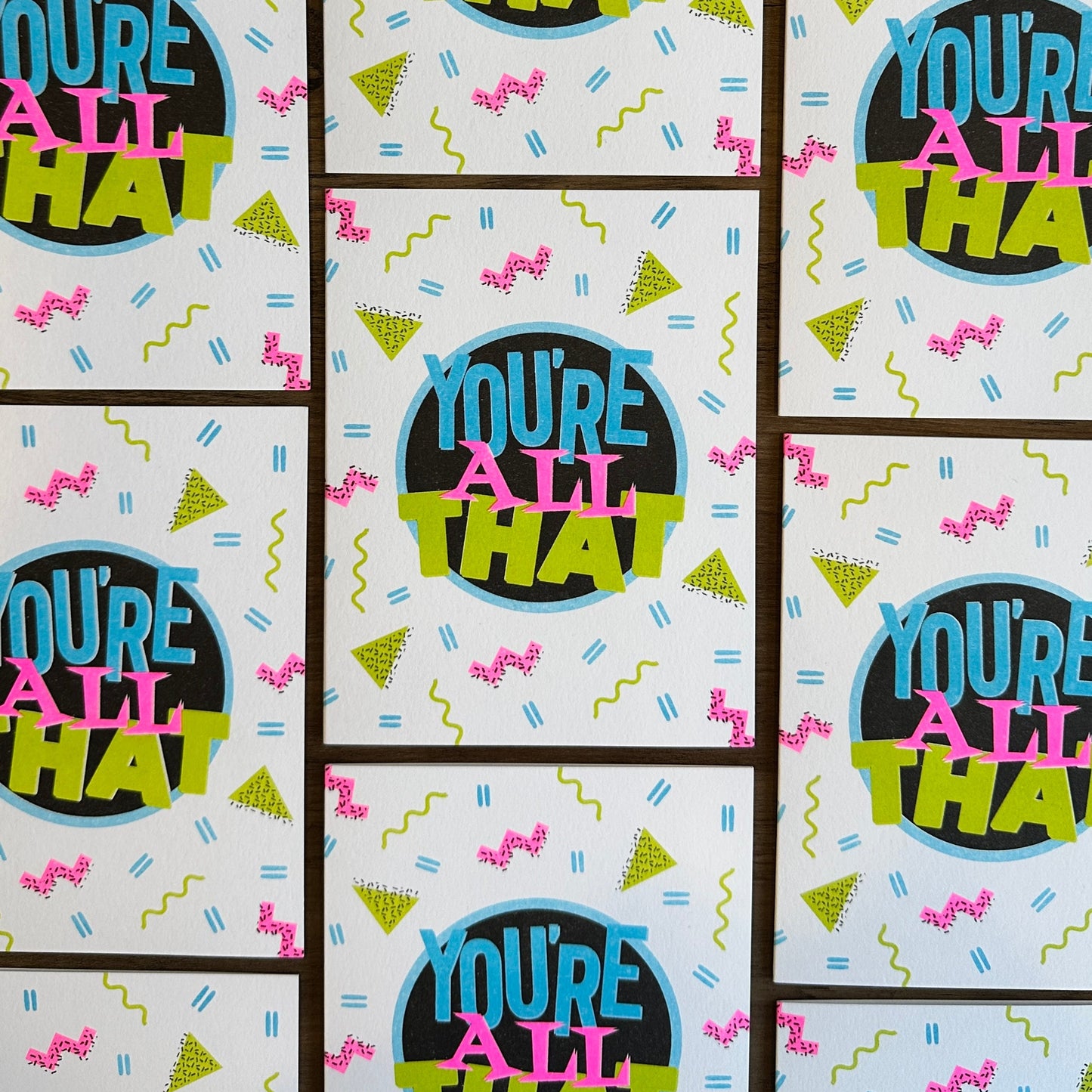 Pattern of 'You're All That' text on a light blue background with colorful text and shapes.