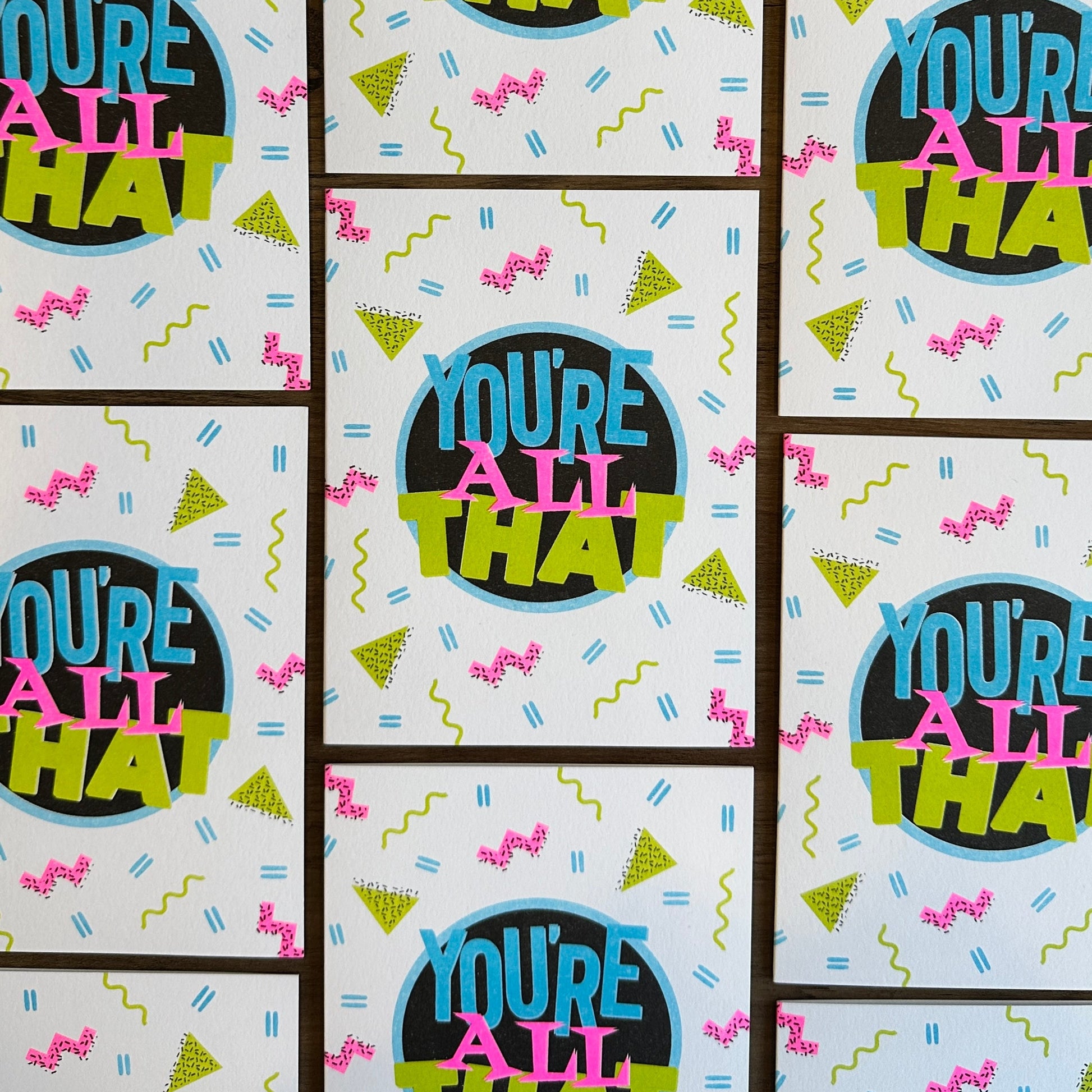Pattern of 'You're All That' text on a light blue background with colorful text and shapes.